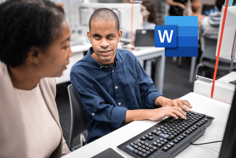 Blind Man Typing on Keyboard in Office Setting. Woman Sitting Next to Him Observing