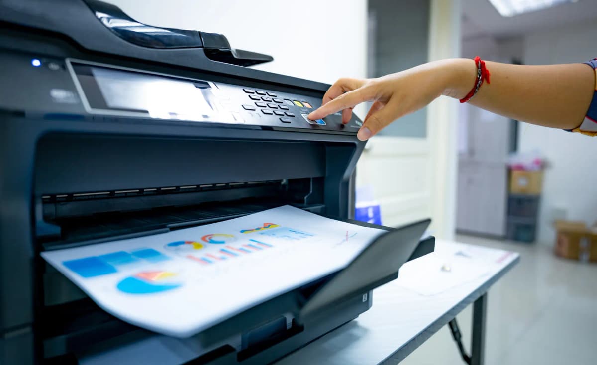 An office worker prints paper on a multifunction laser printer