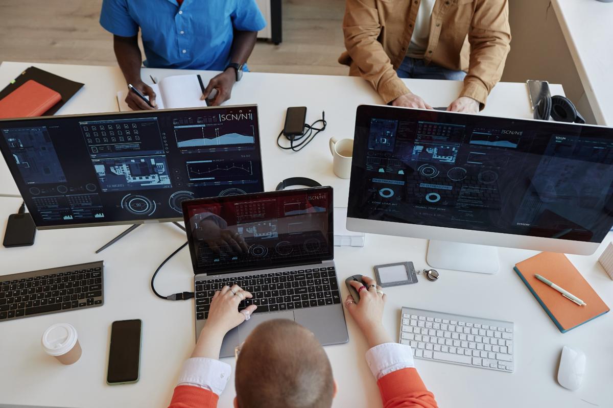 Diverse team of web accessibility testers at workstations testing WCAG compliance, mobile-friendly UI, and inclusive design with DARTSuite tools.