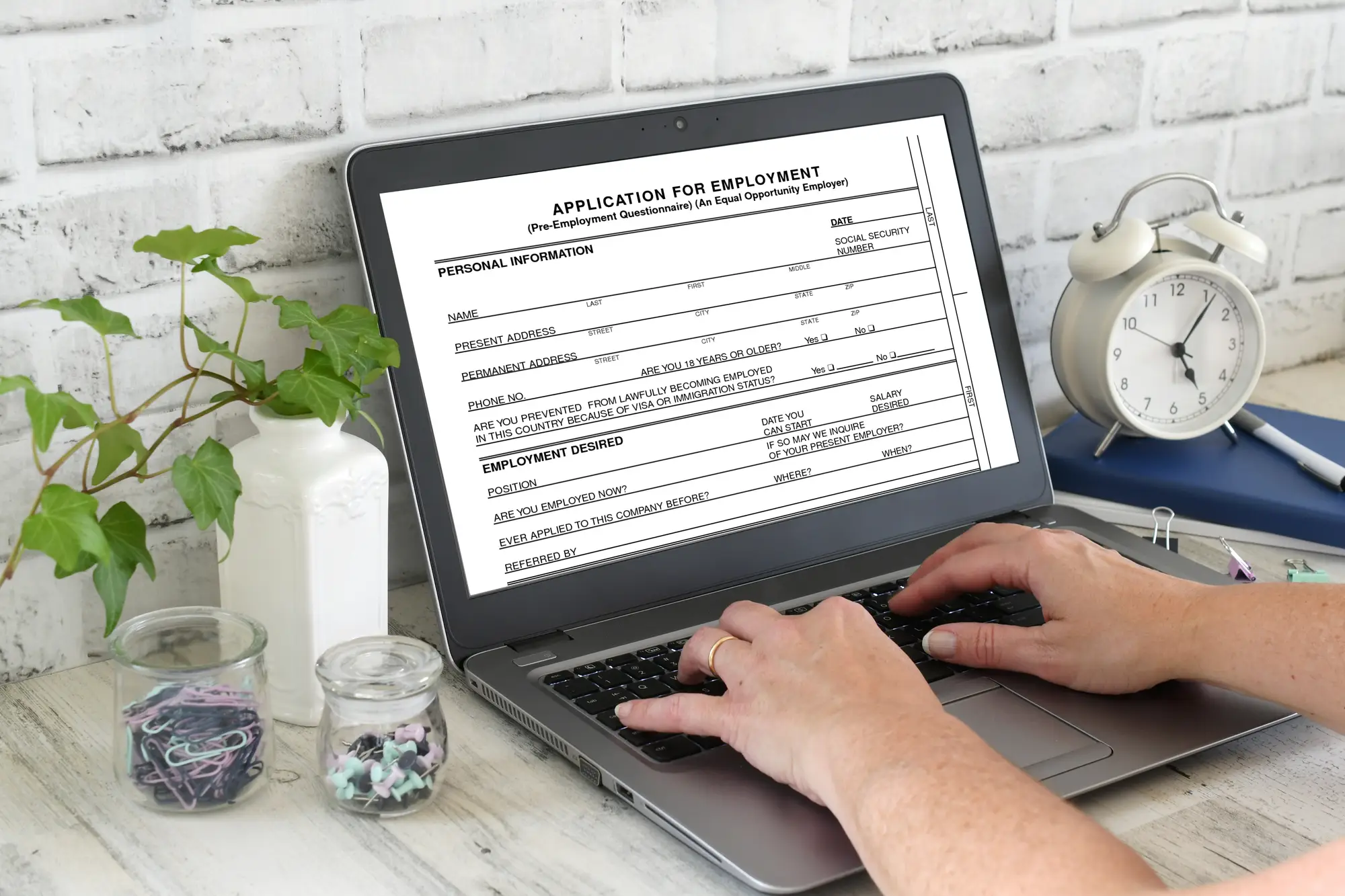 A person filling out an application for employment online on a laptop