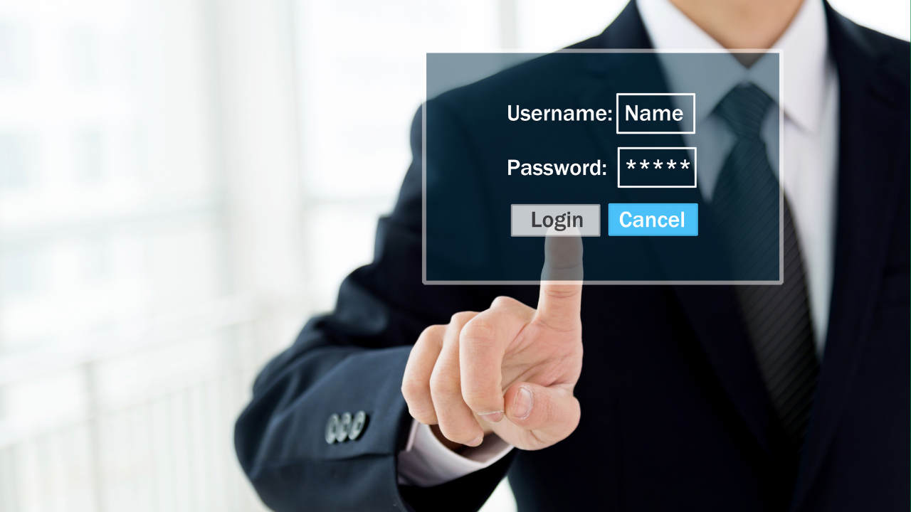 A businessman in a suit is shown pressing a virtual login button on a transparent screen with fields for Username (filled in with &ldquo;Name&rdquo;) and Password (shown as asterisks), plus Login and Cancel buttons.
