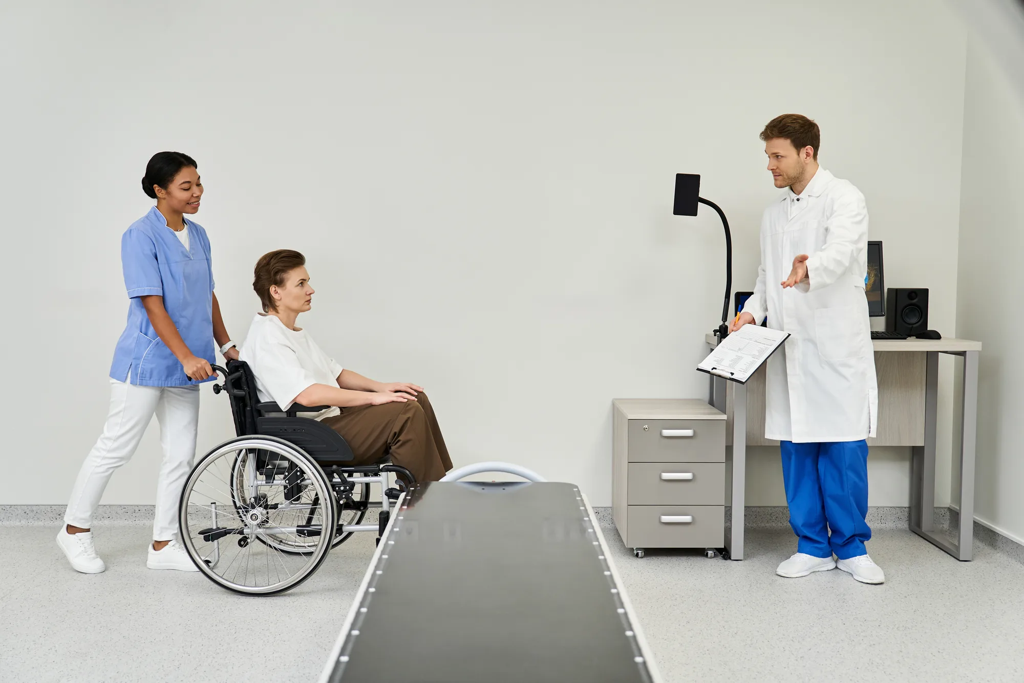Wheelchair user with nurse and doctor at exam table