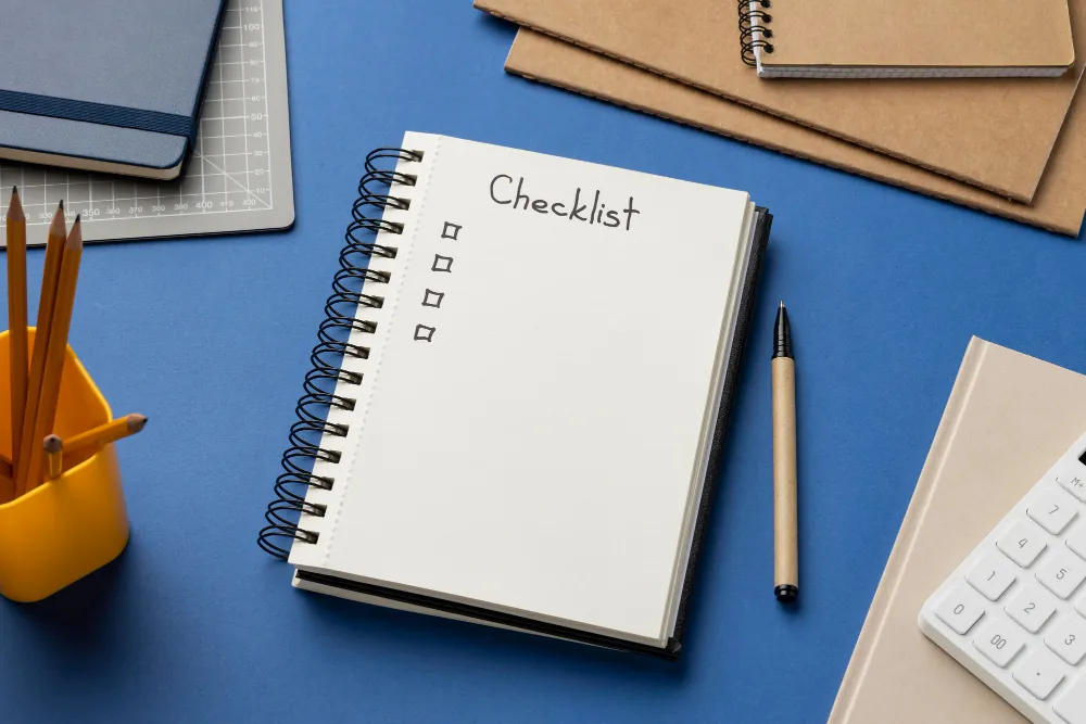 Spiral notebook with 'Checklist' written at top and empty checkboxes